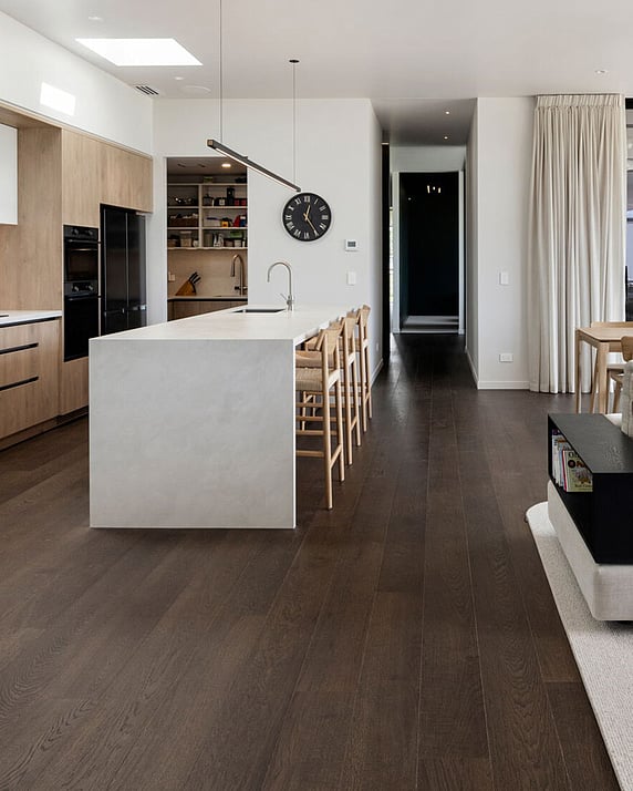 Natural wood floor and black fireplace in a lounge setting.