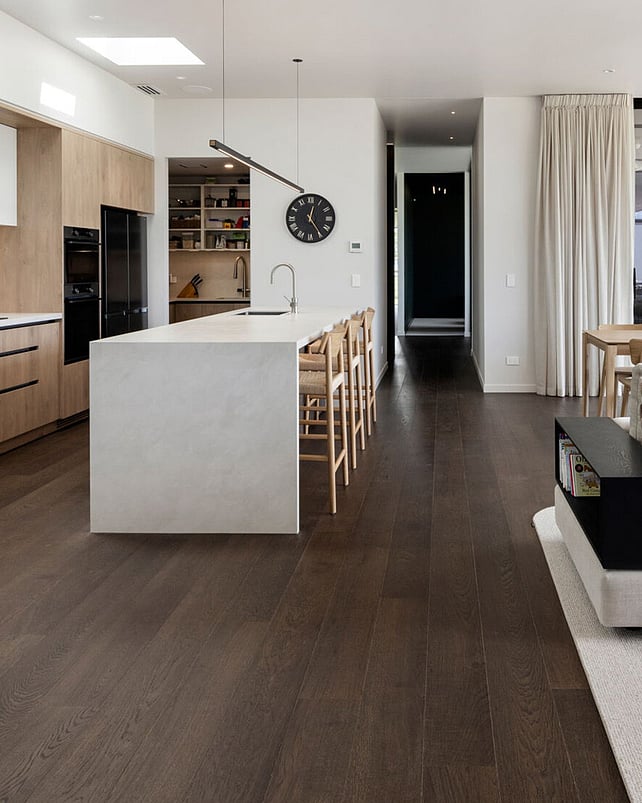 Natural wood floor and black fireplace in a lounge setting.