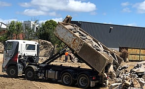truck tipping waste concrete hard fill at tipping site Auckland