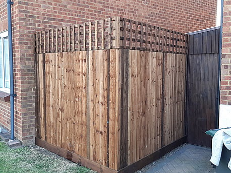 Closeboard fencing with trellis.  Built on timber posts, treated in brown tanatone.