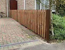 Image shows a run of 90cm high timber picket fence comprising Durapost posts, cant rails and pointed timber pickets.