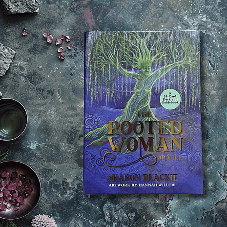 The Rooted Woman Oracle Deck by Sharon Blackie on a Moss and gem background