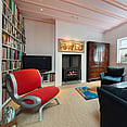 Old Mill House lounge area with tv and red chair.
