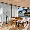 Shift House living area opening to patio with corner sliding doors