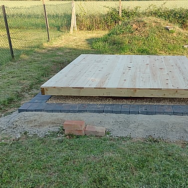 Image shows the finished timber floor for the summer house. I have treated the floor with clear wood preserver to protect from damp though no timber is in contact with the ground. Next step is to start refitting the walls, then the roof. 