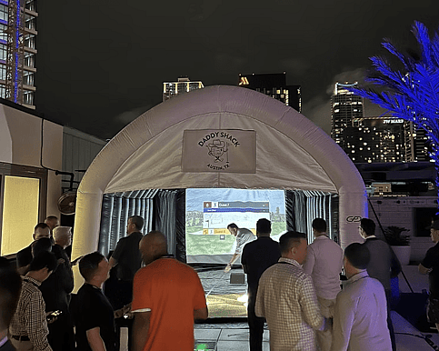 Corporate team bonding and socializing with golf simulator