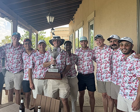 People posing with golf trophy