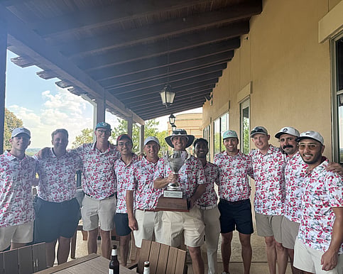 People posing with golf trophy