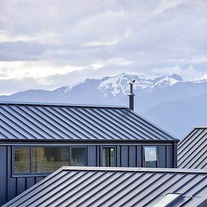 Looking out over the alpin tray rooflines of the house towards the mountains.