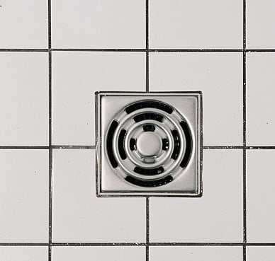 Floor grate installed in a tiled floor