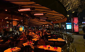 Side-walk dining ready for visitors with heaters ready when it gets cool.