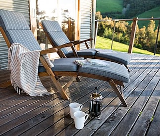 comfy deck chairs with coffee and rug set up for relaxing