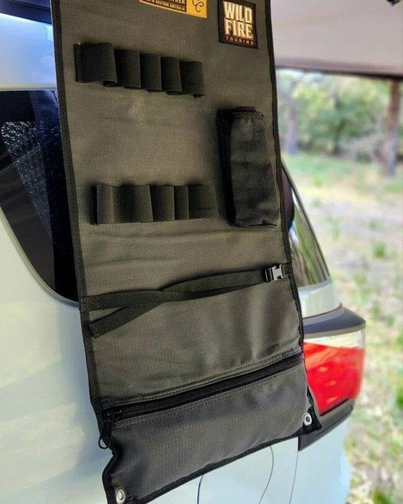 Charcoal canvas WildFire Touring camp kitchen organiser with elastic loops and a mesh pocket hanging inside a 4WD canopy