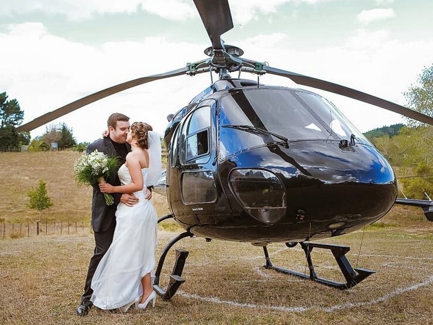 Bride and groom with a helicopter arrival at Settlers Country Manor in Auckland