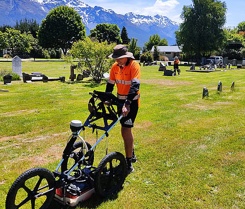 Scientist surveying cemetery