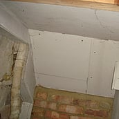 Asbestos insulation board to the ceiling of an understairs cupboard
