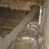 Asbestos insulation debris on a loft floor