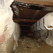 Asbestos insulation to pipe work within a floor duct