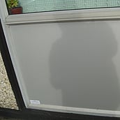 Asbestos cement panel under a window