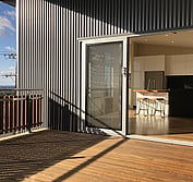 View from deck above carport into dining room and kitchen.