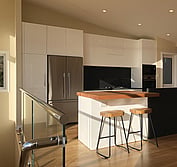 Custom kitchen design featuring two-pac painted panels, honed black and polished Blue Pearl granite, and Tassie Oak butcher block to match the flooring.