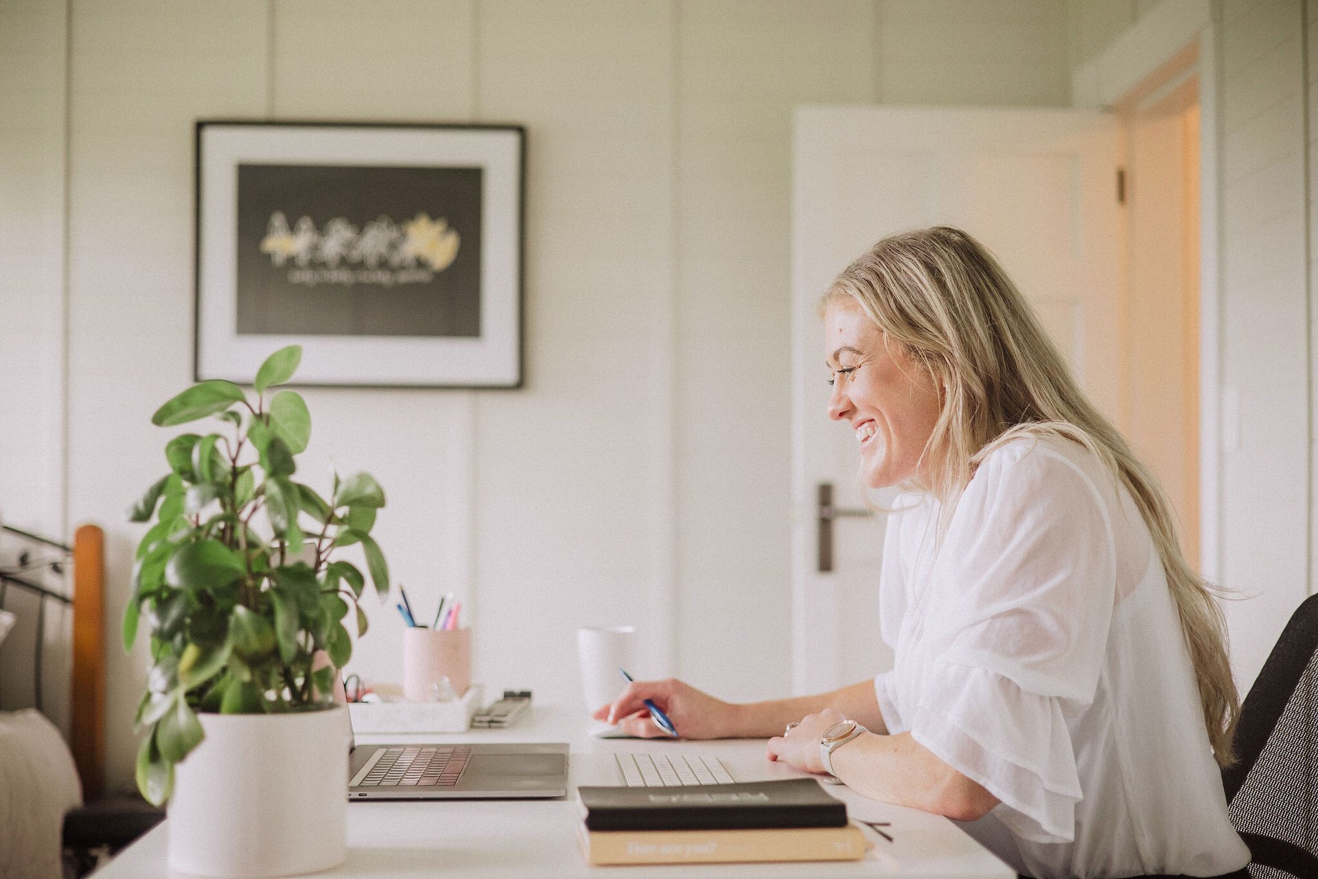 Maria at her desk with her laptop