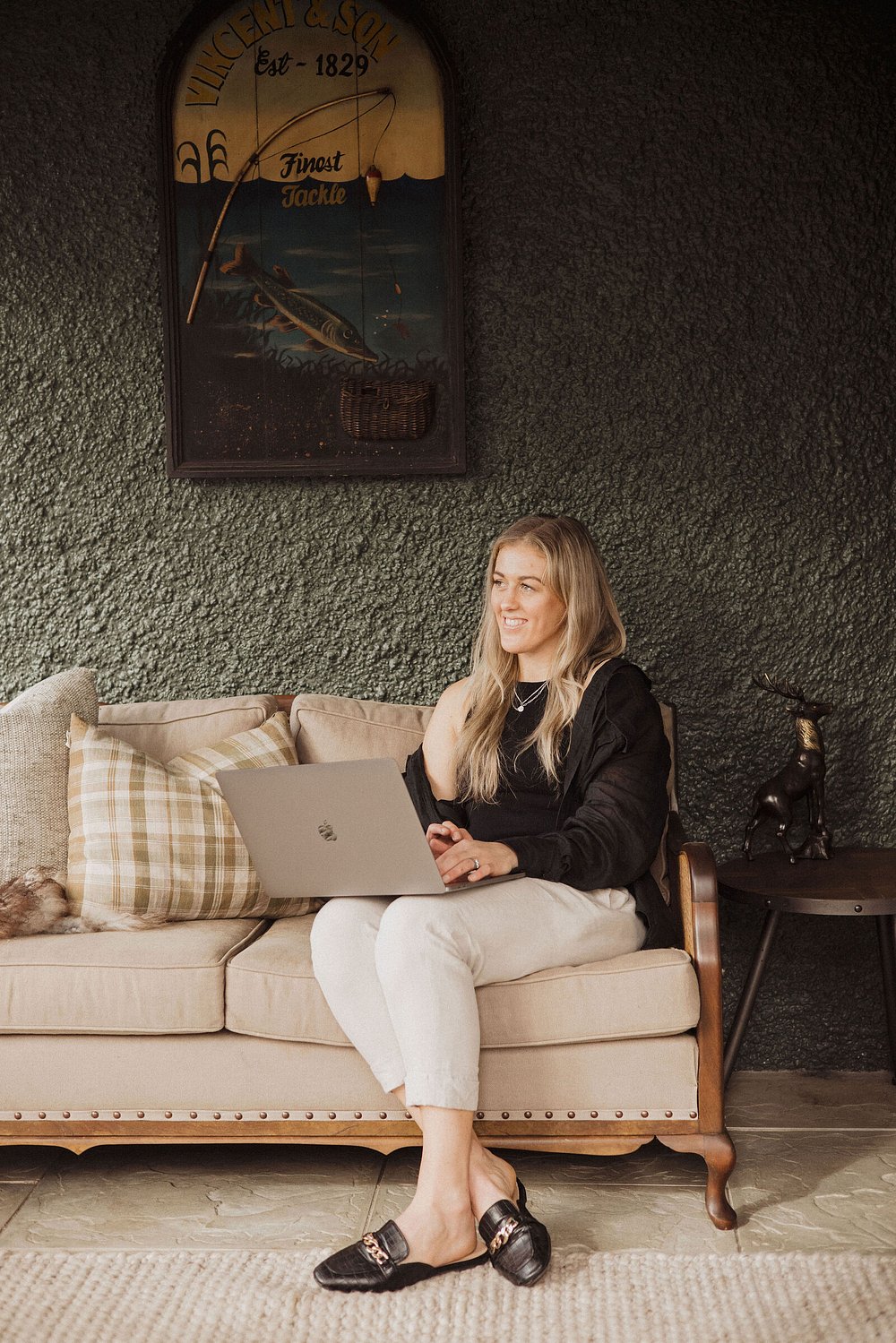 Maria working on her laptop on a couch