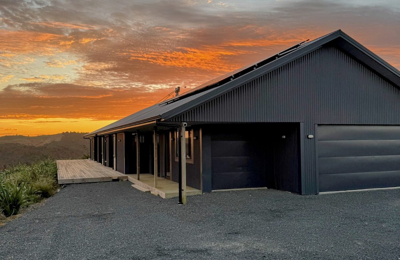 Image of dark cladded new build home with Waikato rural outlooks. Built by Otorohanga builders, Coull Builders.