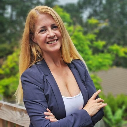 Amber Dixon OnPoint EVA leaning to the side in navy blazer and white singlet, straight blonde hair.