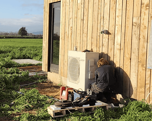 Technician servicing a commercial air conditioning unit in Hamilton
