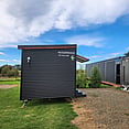Cool as Cabins, Eastern Bay of Plenty. Delivering another cabin or sleepout by towing onsite with their truck.