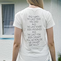 Person standing with their back to the camera wearing a shirt displaying a written message about purpose and values