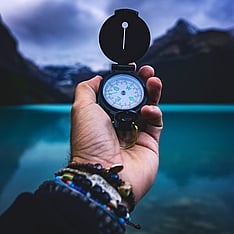 hand holding compass