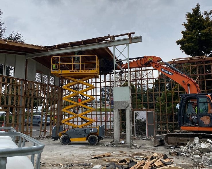 Excavator and scissor lift on a commercial building strip-out