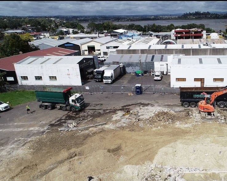 Overhead view of a commercial demolition site with sorted material