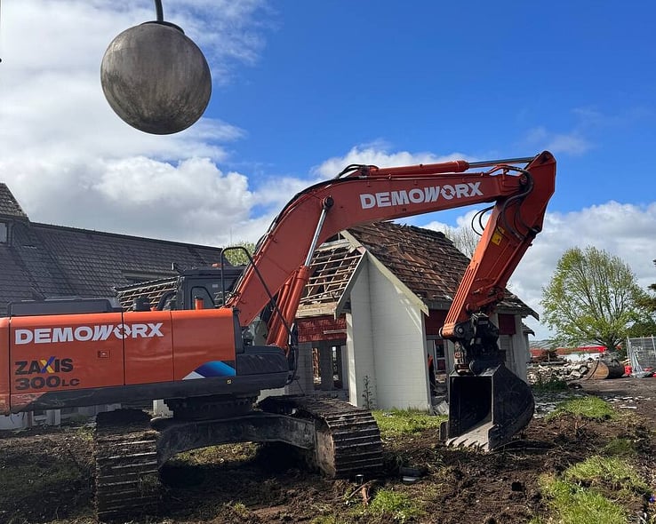 Demoworx excavator on a house demolition site