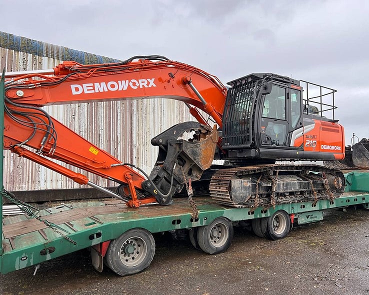 Demoworx excavator loaded on a transporter trailer