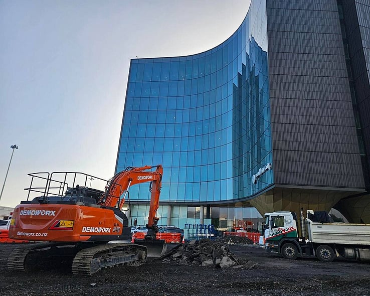 Demoworx excavators and trucks on a cleared commercial site