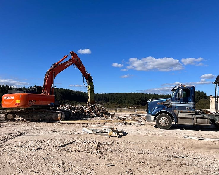 Excavator and truck on a large cleared site