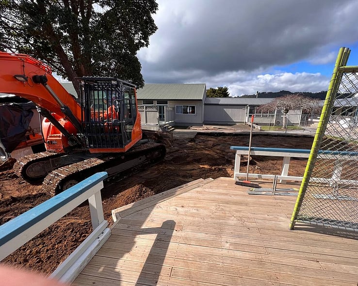 Excavator removing a timber deck