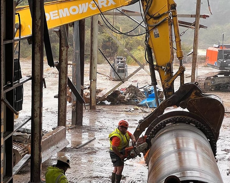Worker in hi-vis among cut steel pipe during an industrial strip-out
