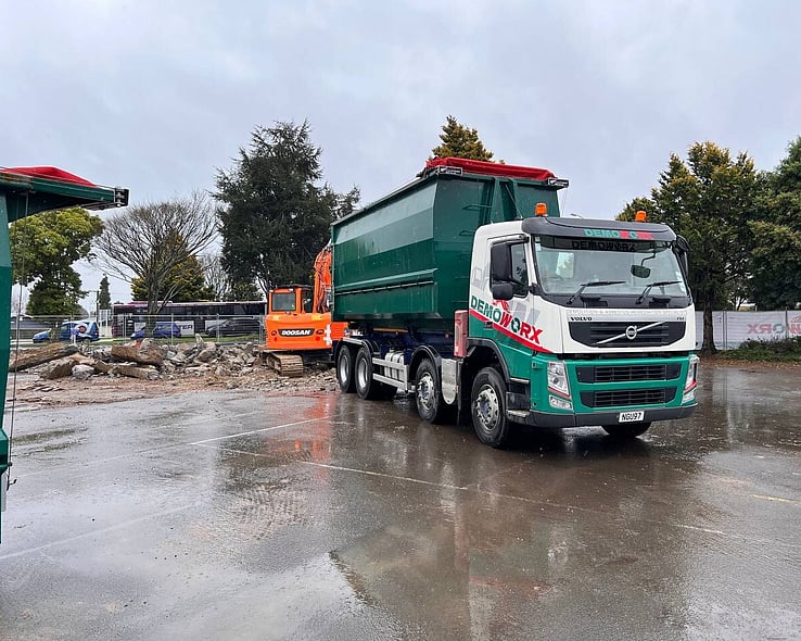 Demoworx bin truck on a wet cleared site