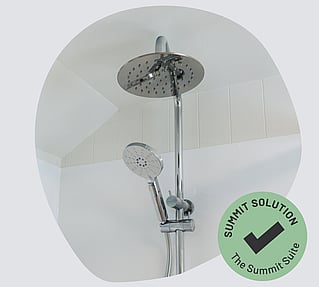A close up of a chrome double shower head unit. 