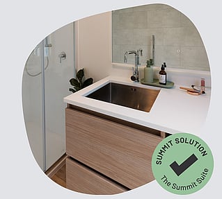 A stainless steel sink in a vanity unity.