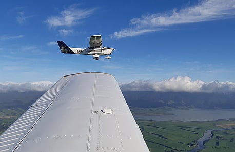 Our Cessna 172 ZK-EKE flies on the wingtip over the southern Wairarapa