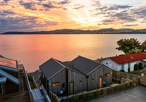 Aerial view of Roam Taupo units with Lake Taupp sunset in the background