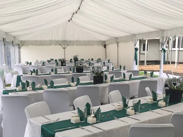 Decorated trestle tables with linen and floral runners &ndash; wedding trestle table hire Auckland
