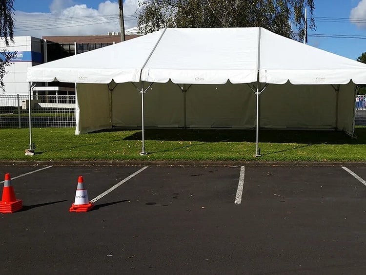 Empty white marquee on grass field &ndash; marquee only hire Auckland