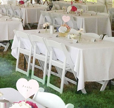 Decorated trestle tables with linen and floral runners – wedding trestle table hire Auckland