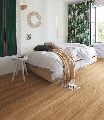 Waterproof hybrid vinyl floor in a modern bedroom.